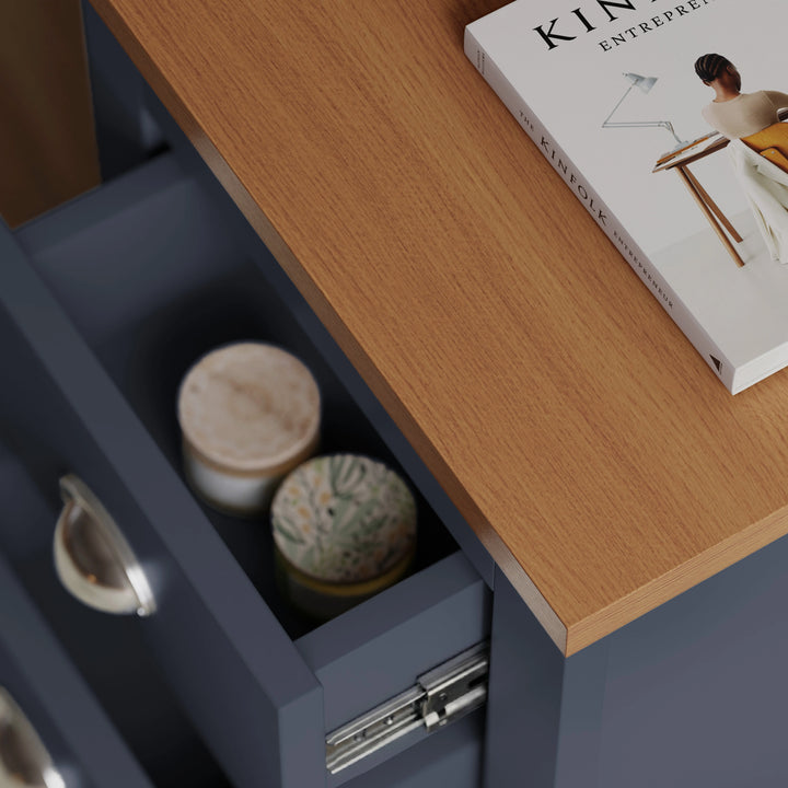 [Blue] close up of oak effect top and open drawer with two ceramic candles inside blue shaker bedside