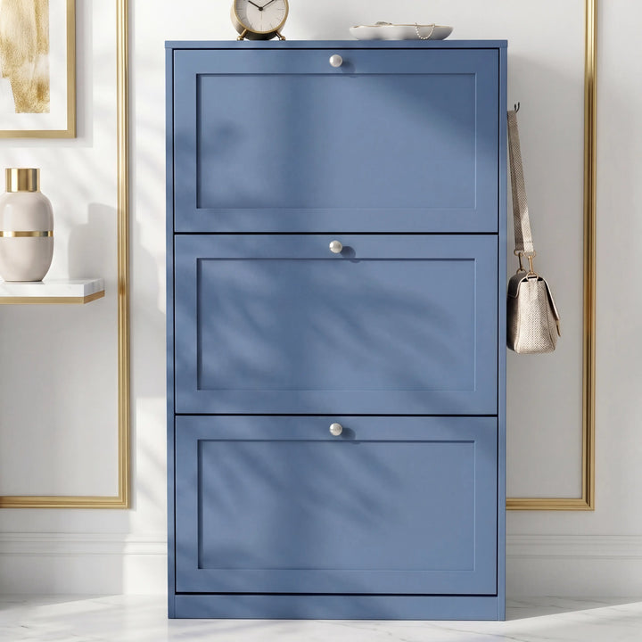 [Blue] Shaker Shoe Cabinet closed three-door flip-front unit against white panelled wall with woven basket and linen tote bag alongside