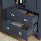 [Blue] close-up of blue shaker wardrobe drawers with brushed metal handles, showing deep storage for clothes and accessories with side runners
