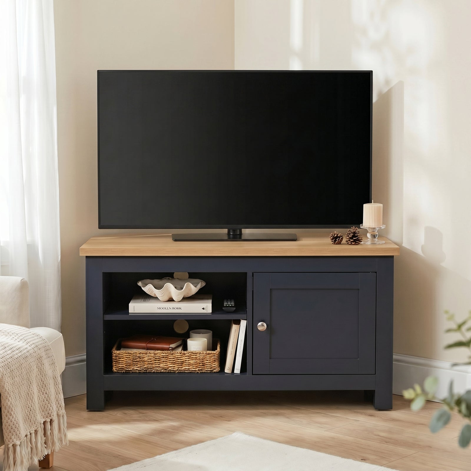 [Blue] Tavero Blue Corner TV Unit with Storage front view in warm beige corner setting with oak top, two open shelves, shaker door and brushed nickel knob
