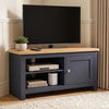 [Blue] TV stand with a light wood top, shown in a styled living room setting with a flat-screen TV, a small potted plant, and decorative items on the shelves.