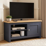 [Blue] TV stand with a light wood top, shown in a styled living room setting with a flat-screen TV, a small potted plant, and decorative items on the shelves.