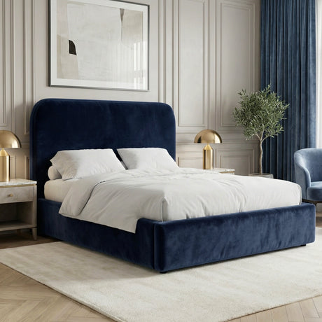 Blue velvet king ottoman storage bed placed in a bright interior with a padded headboard and upholstered frame