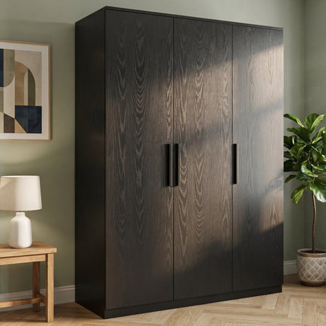 [Black] Blythe wardrobe in bedroom setting with framed art on left and a leafy plant to the right