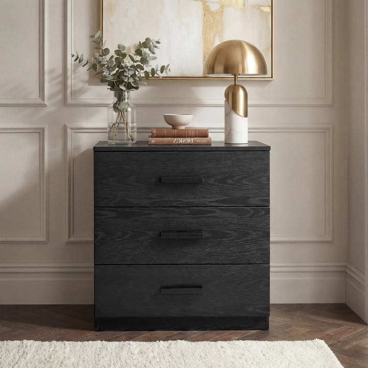 [Black] Blythe bedroom furniture set 3 drawer chest shown head on against a cream panelled wall