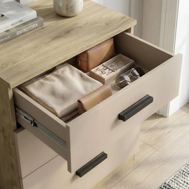[Oak Cashmere] Close view of the Blythe bedroom furniture set chest top drawer showing oak edge and black handle