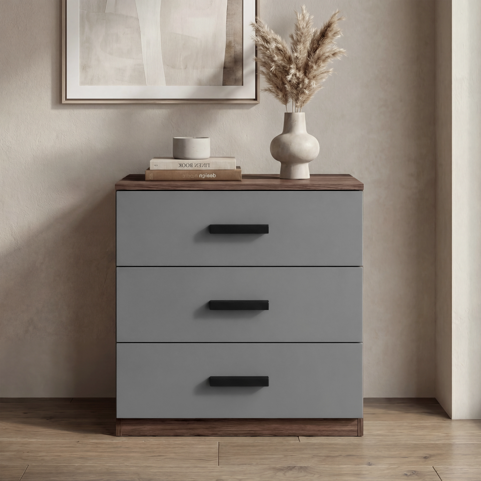 [Walnut] Blythe bedroom furniture set 3 drawer chest closed beside artwork with books and vase on top