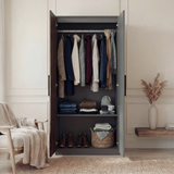 [Walnut] Blythe bedroom furniture set wardrobe doors open in styled room with chair and throw beside it