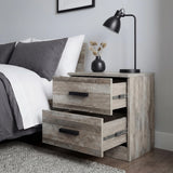 [Ash Grey] Blythe bedside table with upper and lower drawers pulled out at different depths next to bed and desk lamp