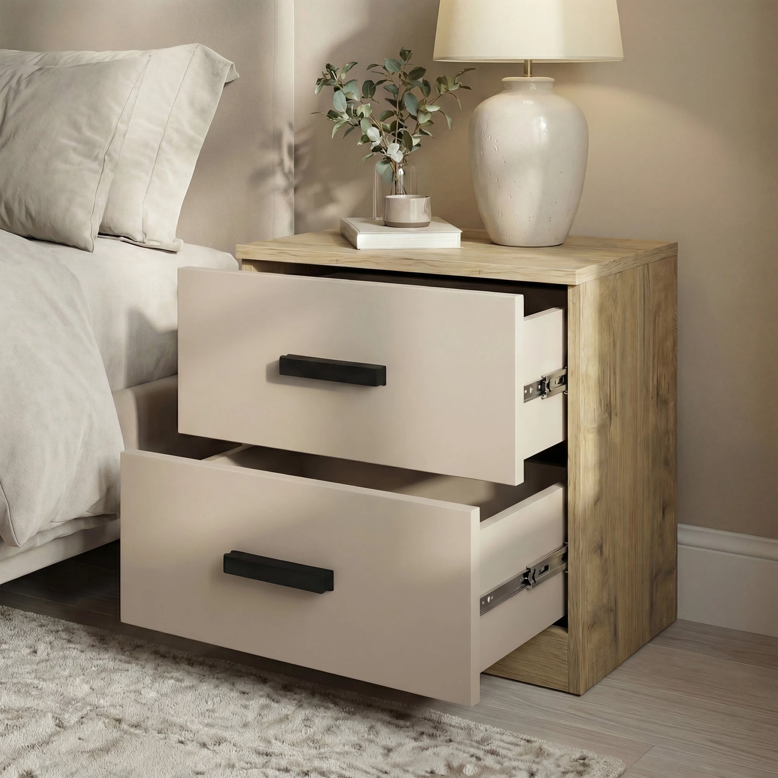 [Oak Cashmere] Bedroom view of bedside table with both drawers pulled open beside bed, ceramic lamp and stems on top