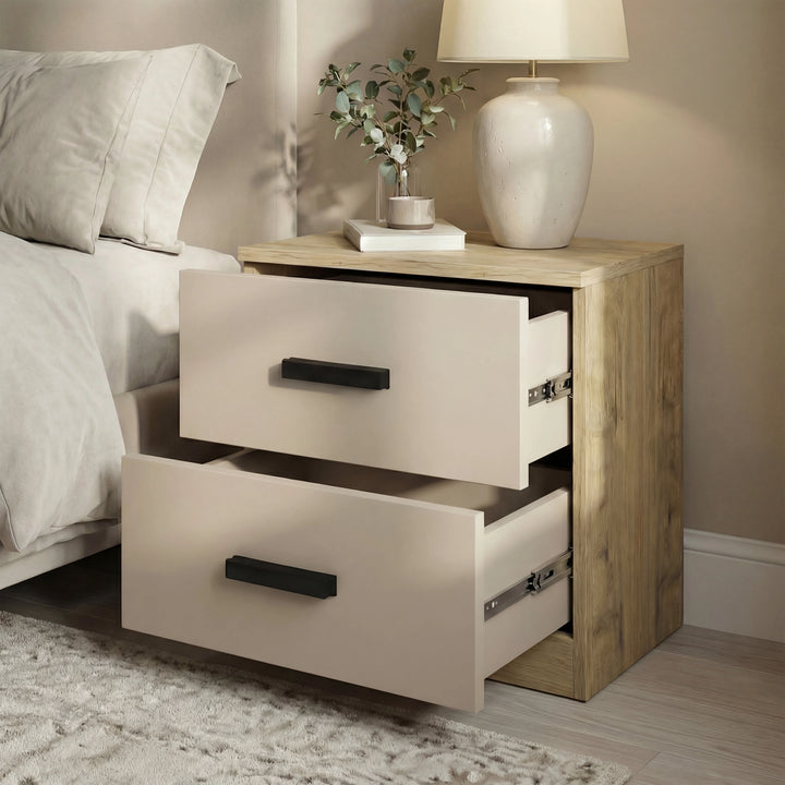 [Oak Cashmere] Bedroom view of bedside table with both drawers pulled open beside bed, ceramic lamp and stems on top