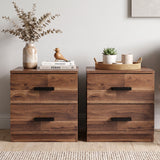 [Dark Bronx] Two drawer nightstands with dark metal handles, styled in a bright room with plants, a vase of dried flowers, and a small basket on top.