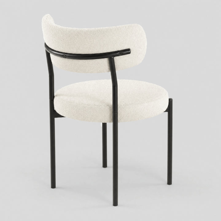 [Cream | Set of 4] Back studio view of boucle dining chair showing curved backrest and black iron support frame.