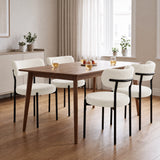 [Cream | Set of 4] Four boucle dining chairs around a rectangular wooden dining table in a bright room.