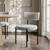 [Light Grey | Set of 4] Boucle dining chair beside a round table, showing curved back and slim black legs.