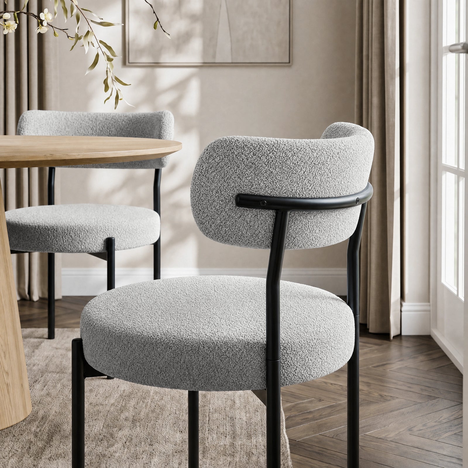 [Light Grey | Set of 4] Rear lifestyle view of boucle dining chair with curved backrest and black metal frame.