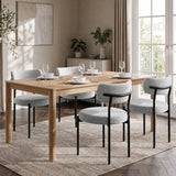 [Light Grey | Set of 4] Four boucle dining chairs around a rectangular wooden dining table in a bright room.