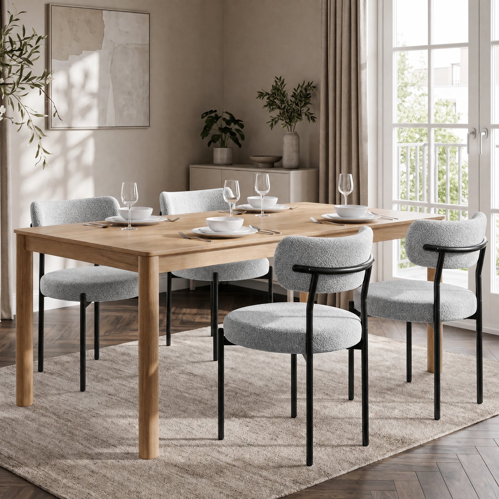 [Light Grey | Set of 4] Four boucle dining chairs around a rectangular wooden dining table in a bright room.