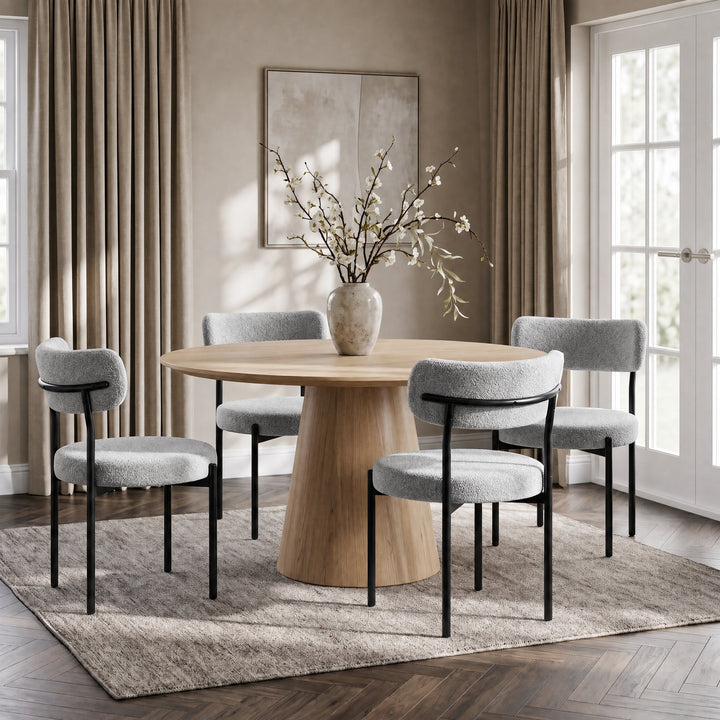 [Light Grey | Set of 4] Four boucle dining chairs around a round wooden table in a bright dining room.