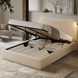 Curved Headboard Ottoman Storage Bed in beige boucle fabric with gas lift mechanism open, revealing spacious underbed storage with folded bedding.