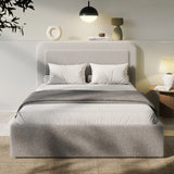Boucle upholstered ottoman storage bed with curved headboard in light grey, featuring gas-lift storage and modern platform design. Ideal for stylish bedrooms.