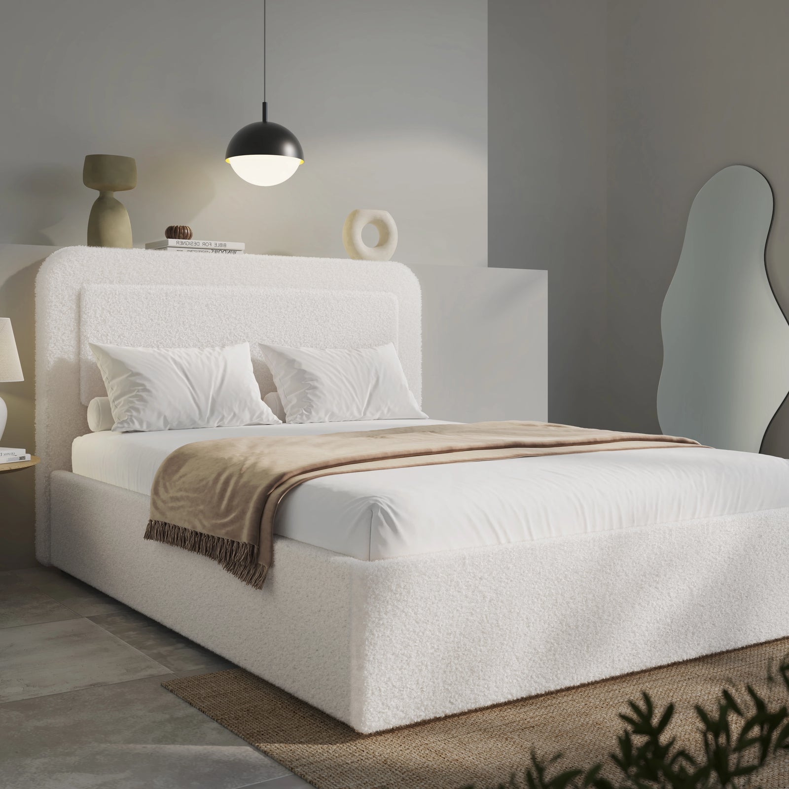 Side view of double white boucle bed, low storage base and pendant overhead in pale styled bedroom