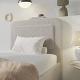 [Single | Grey] Close-up of rounded headboard showing soft boucle fabric texture with curved pill-shaped profile