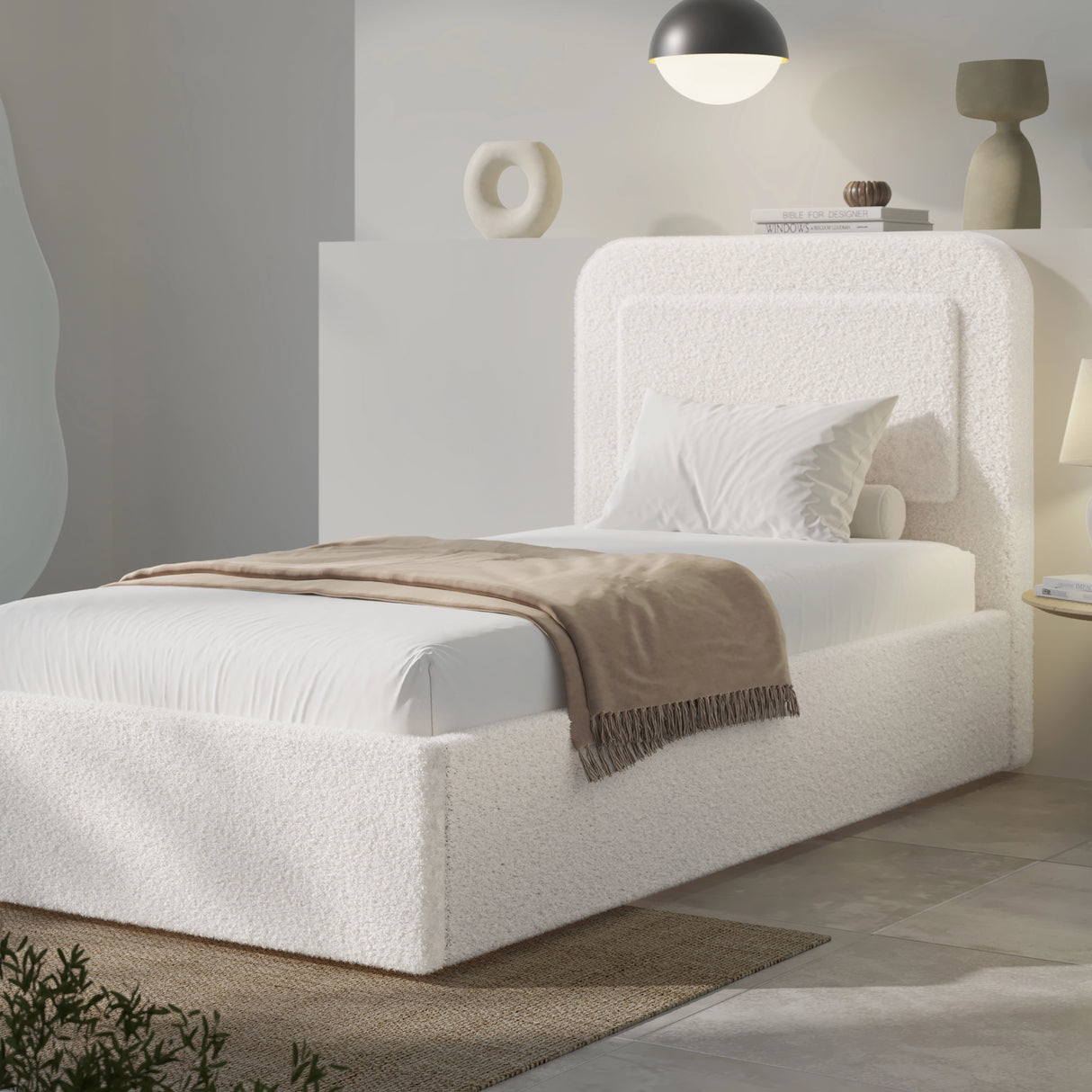 [Single | White] Front view of boucle ottoman bed with curved headboard and styled bedding in contemporary bedroom