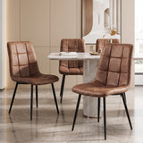 [Brown] Three suede dining chairs around a pale stone-effect table, showing tufted fronts and slim black legs.