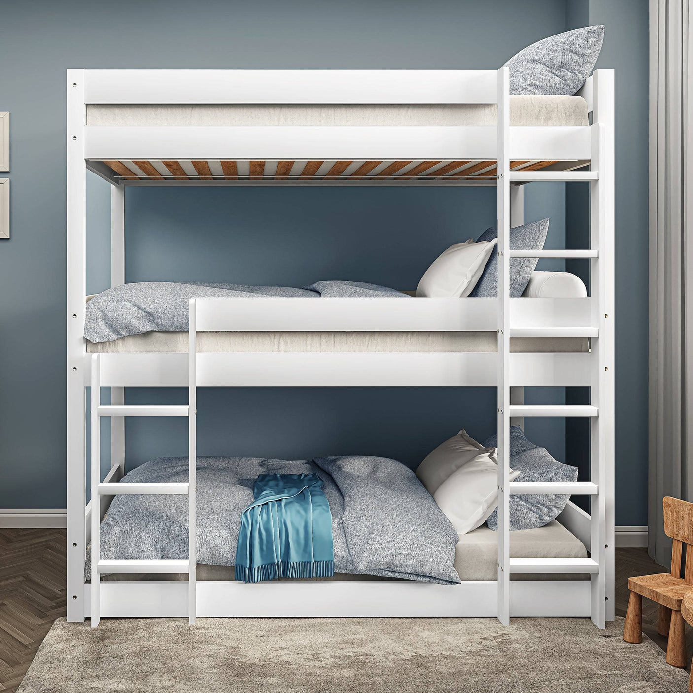 Front view of white triple bunk bed with safety rails and ladders, designed for kids and teens in compact bedrooms.