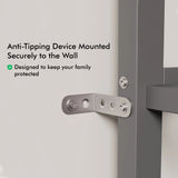 Close up of metal anti tipping mechanism attached to a wall and a single bunk bed with desk.