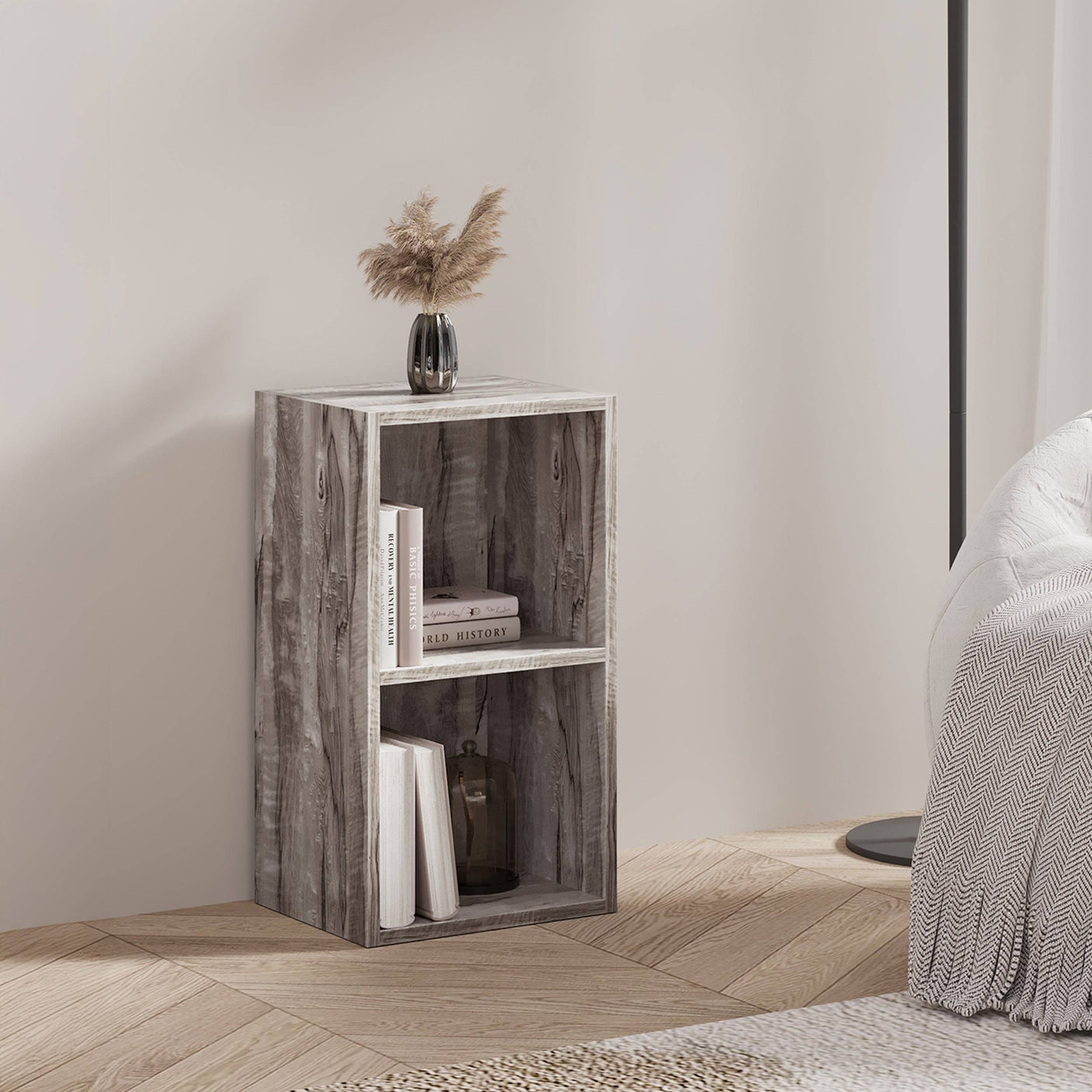Rustic wood Blisswood bookcase used as a nightstand, styled with books and a vase in a bedroom.