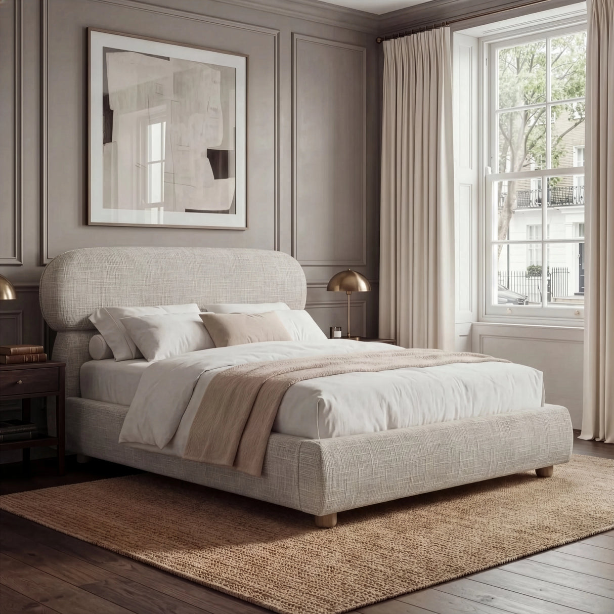 Camel upholstered king bed positioned in a spacious bedroom, styled with layered neutral bedding and warm ambient light