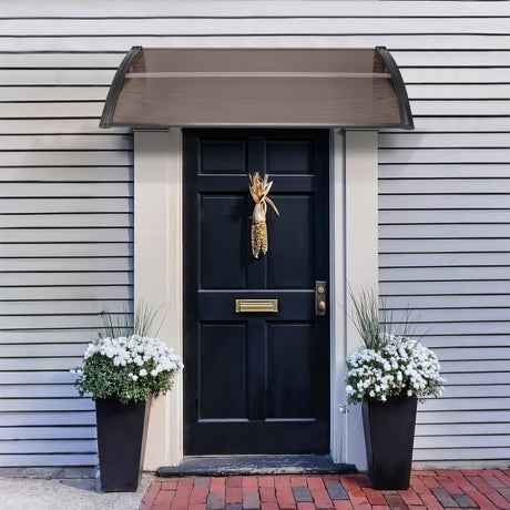 Black canopy above front door with a brown PC sunshade, providing stylish weather protection.