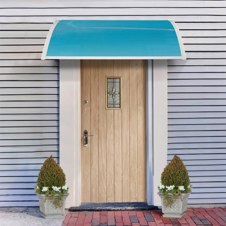 Blue and white canopy for back door with decorative glass, flanked by two potted plants.