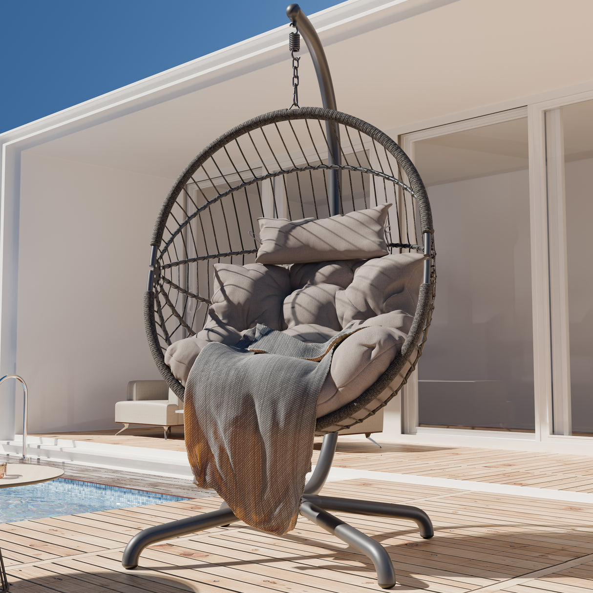 Cheapest hanging egg chair with beige cushions, durable stand, and outdoor patio setting.