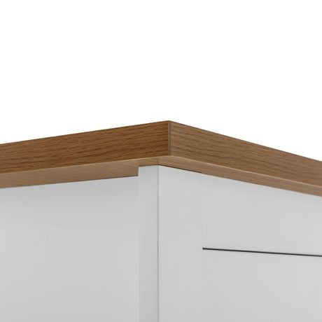 Close-up of oak top on a white chest of 2 drawers, modern furniture design for UK homes.