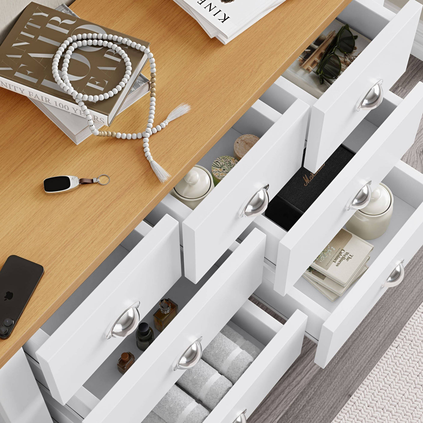 Chest of drawers bedroom furniture with open drawers, inside storage for coffee mugs and books.

