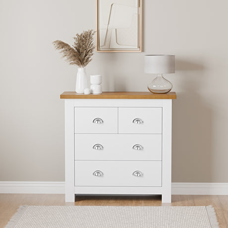 Chest of drawers for small bedrooms with handles, top surface lamp, and flower pot.