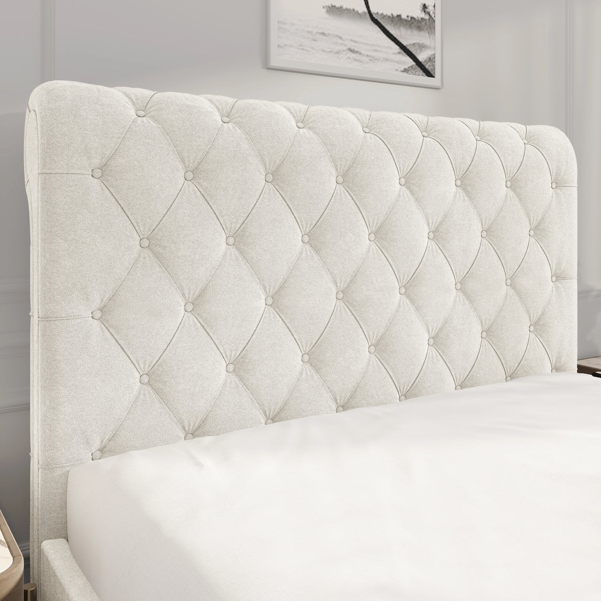 Tufted beige headboard in a bedroom setting