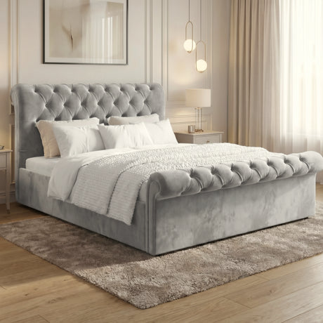 [King | Grey] Side angle king Chesterfield ottoman bed with diamond tufting and grey bedding on rug