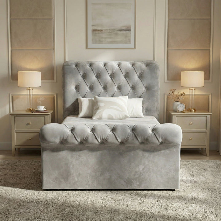 [Single | Grey] Light grey Chesterfield storage bed centred between two lamp-lit nightstands, front facing