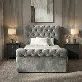 [Single | Dark Grey] Front view of chesterfield ottoman bed with tufted headboard flanked by matching bedside tables