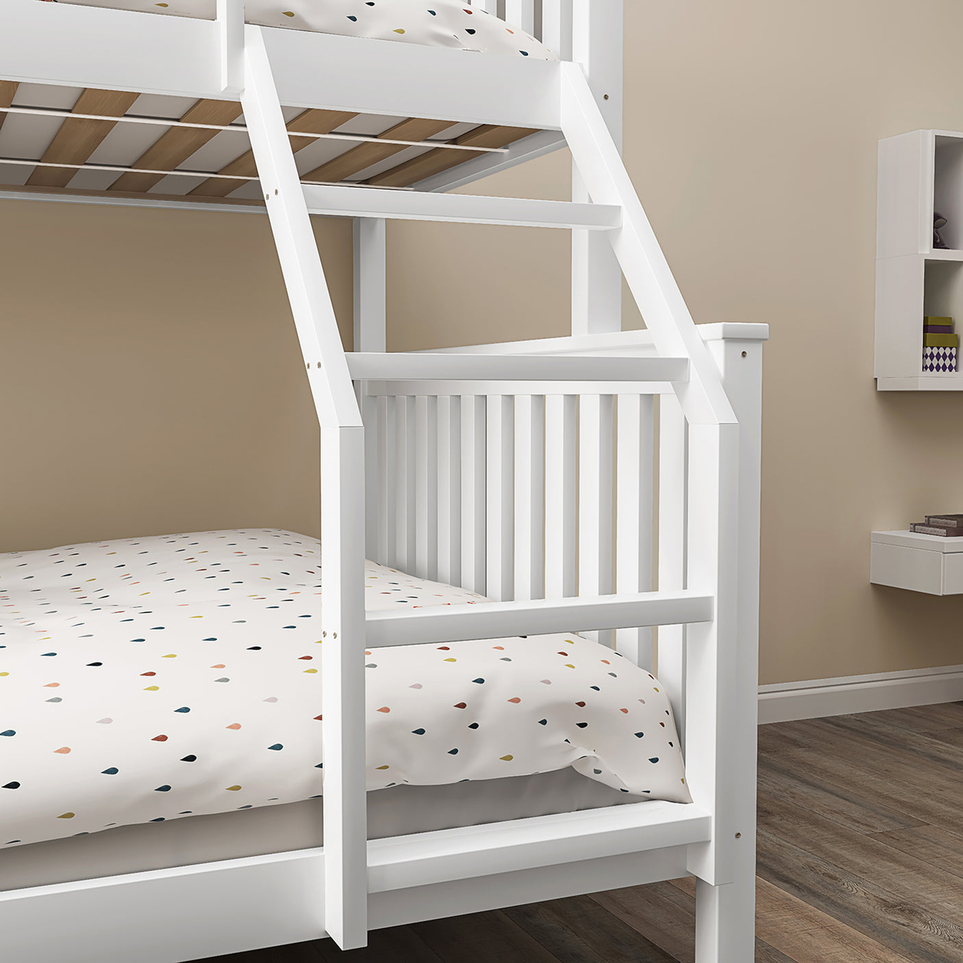 Detail of angled ladder on white triple bunk bed for kids, designed for safe and easy access to the top bunk.