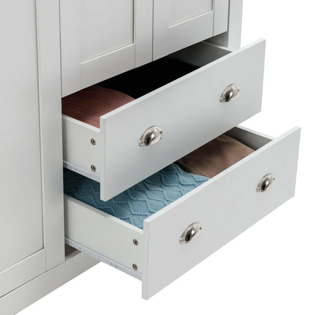 Close-up of two open drawers in a white wardrobe, showcasing ample storage space and silver handles.