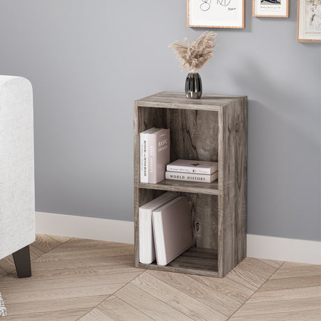 angled front view of 2 tier coach wood rustic bookcase featuring natural grain and styled with books and art