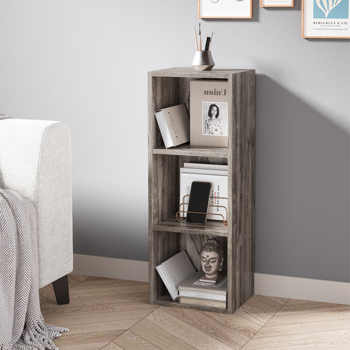 [3 Shelf | Coach Wood] console-height coach-wood-grain bookcase set behind chair by cream limewash wall