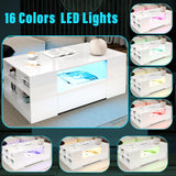 White coffee table with LED lights showing different color options in a living room setting.