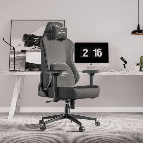 Xstriker Ergonomic Fabric Gaming Chair with 4D Armrest for Adults in a modern home office setup. Features adjustable support and sleek grey fabric.