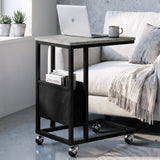 [Concrete] C-shaped side table by sofa with concrete-effect top, black frame, pouch, laptop and caster wheels